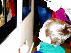 Martina, former model in studio painting with her son